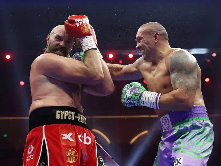 Tyson Fury grimaces as Oleksandr Usyk attacks during their December 2024 rematch
