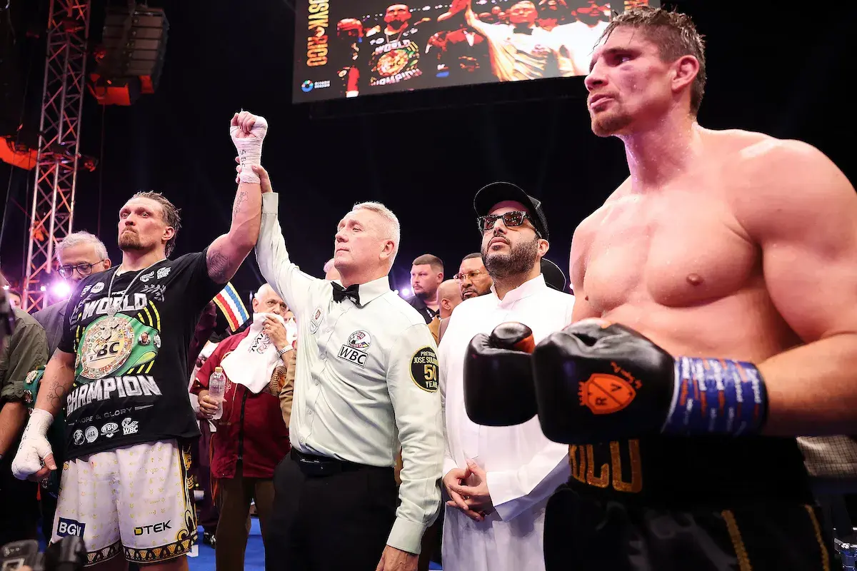 Oleksandr Usyk has his hand held aloft by Mark Lyson having defeated Rico Verhoeven