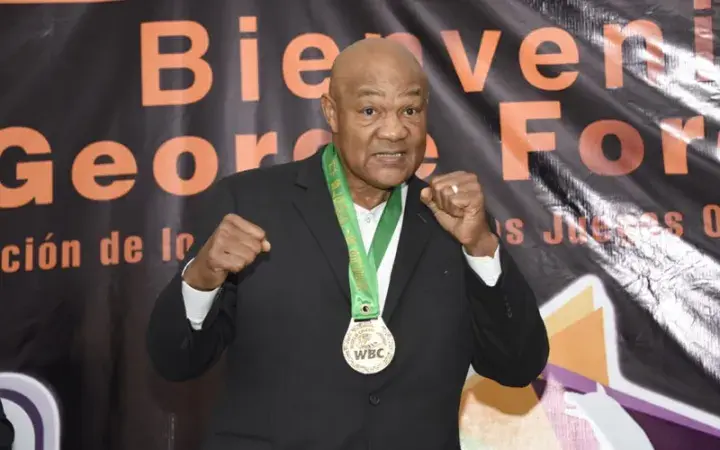 All-time great heavyweight George Foreman poses with a WBC medal.
