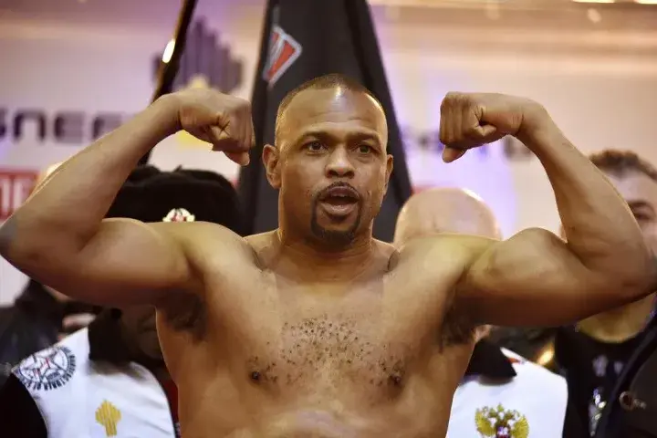 Roy Jones flexes after weighing in for his fight with Enzo Maccarinelli.