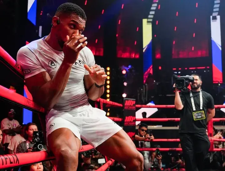 Anthony Joshua leans against the ropes during a media workout on December 16, 2025, ahead of his boxing match with Jake Paul.