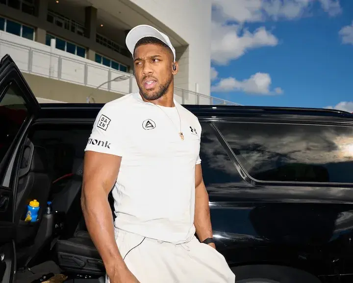 Anthony Joshua stands outside of a vehicle at his press conference on November 21, 2025, for his boxing match with Jake Paul.