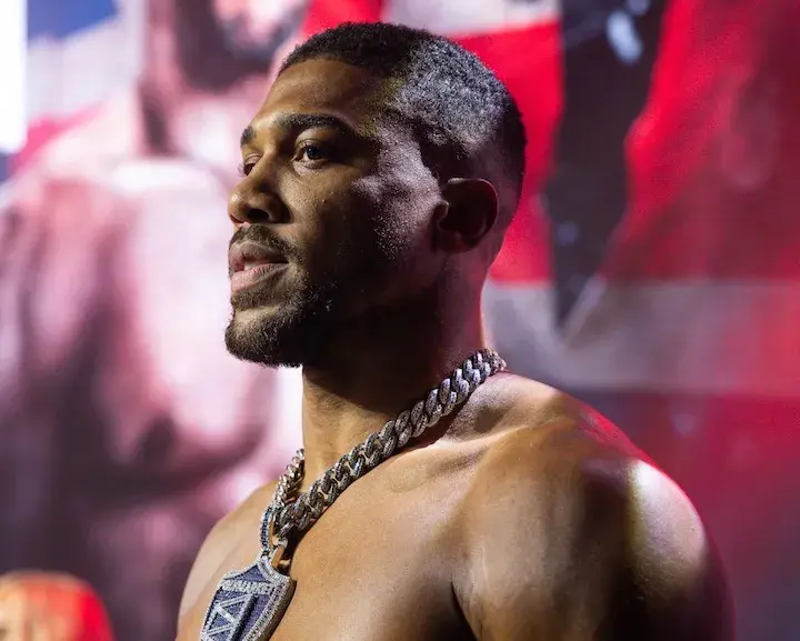 Anthony Joshua stands onstage at the weigh-in on December 18, 2025, for his boxing match with Jake Paul.