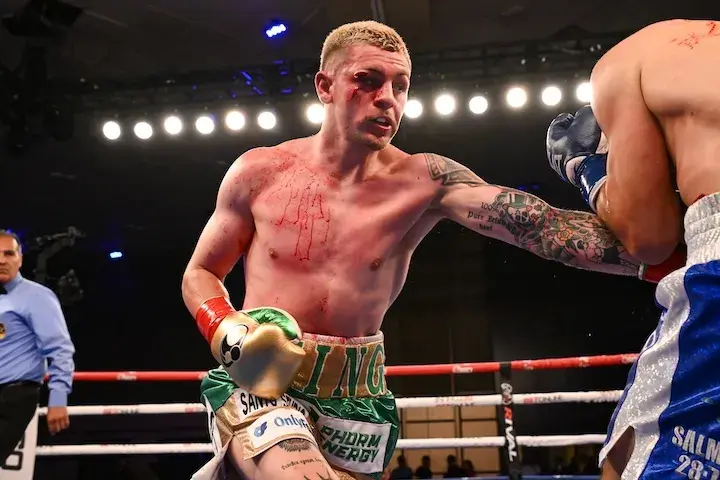 With blood on his chest from a cut over his right eye, Callum Walsh lands a left hand to Elias Espadas during their fight on June 21, 2025.