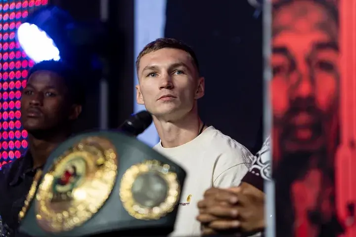 Dzmitry Asanau watches on at a press conference in 2025