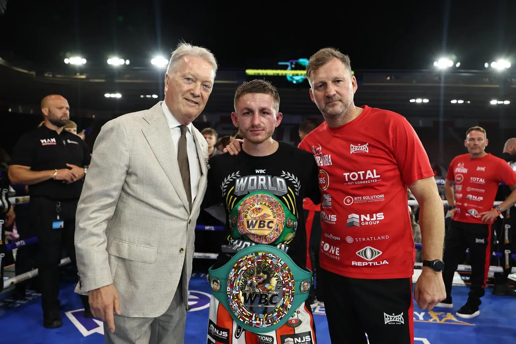 Promoter Frank Warren and trainer Wayne Batten flank Ryan Garner