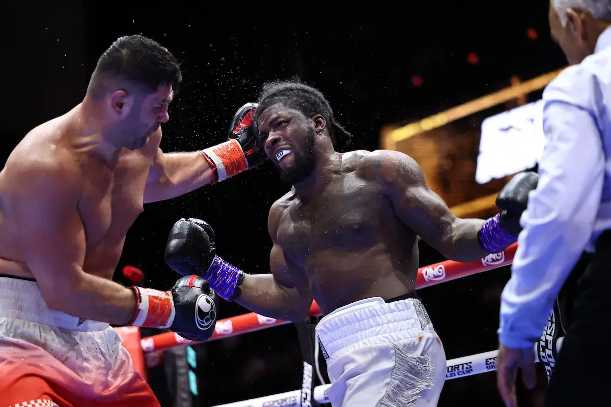 David Adeleye [right] lets fly against Filip Hrgovic in August 2025 but will lose in eight rounds