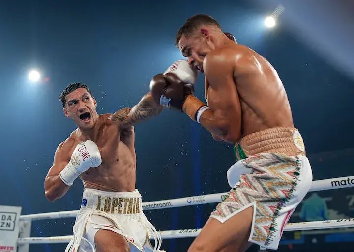 Jai Opetaia sends a big left hand at David Nyika.