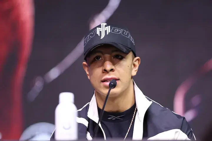 Jaime Munguia sits in front of a microphone at a press conference.