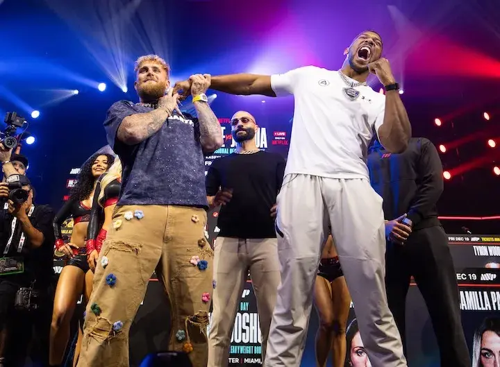 Jake Paul and Anthony Joshua pose for photos at a press conference on December 17, 2025, days before their boxing match.
