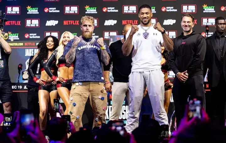 Jake Paul and Anthony Joshua both hold their fists in front of them at a press conference on December 17, 2025, days before their boxing match.