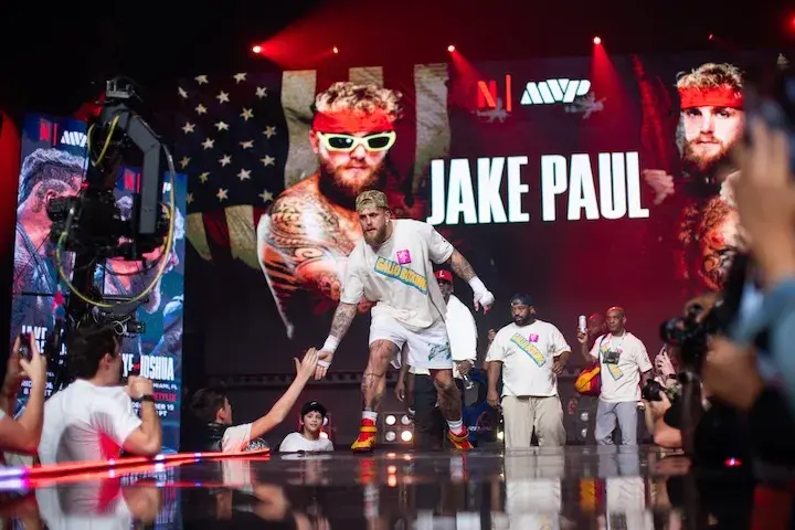 Jake Paul slaps hands with a bystander during a media workout on December 16, 2025, ahead of his boxing match with Anthony Joshua.