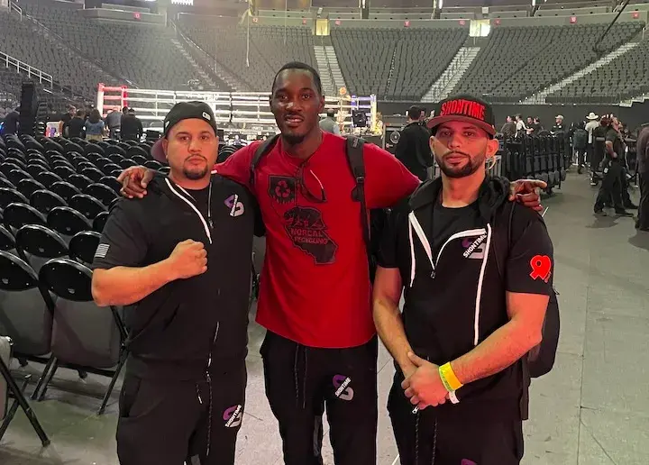 Joeshon James (center) is pictured with trainer AndresMartinez.