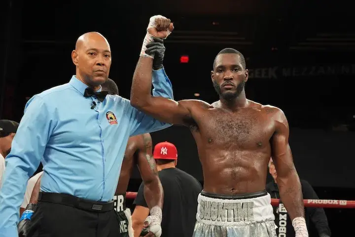 Joeshon James has his hand raised in the air by a referee following his majority decision win over Yojanler Martinez on December 18, 2025.