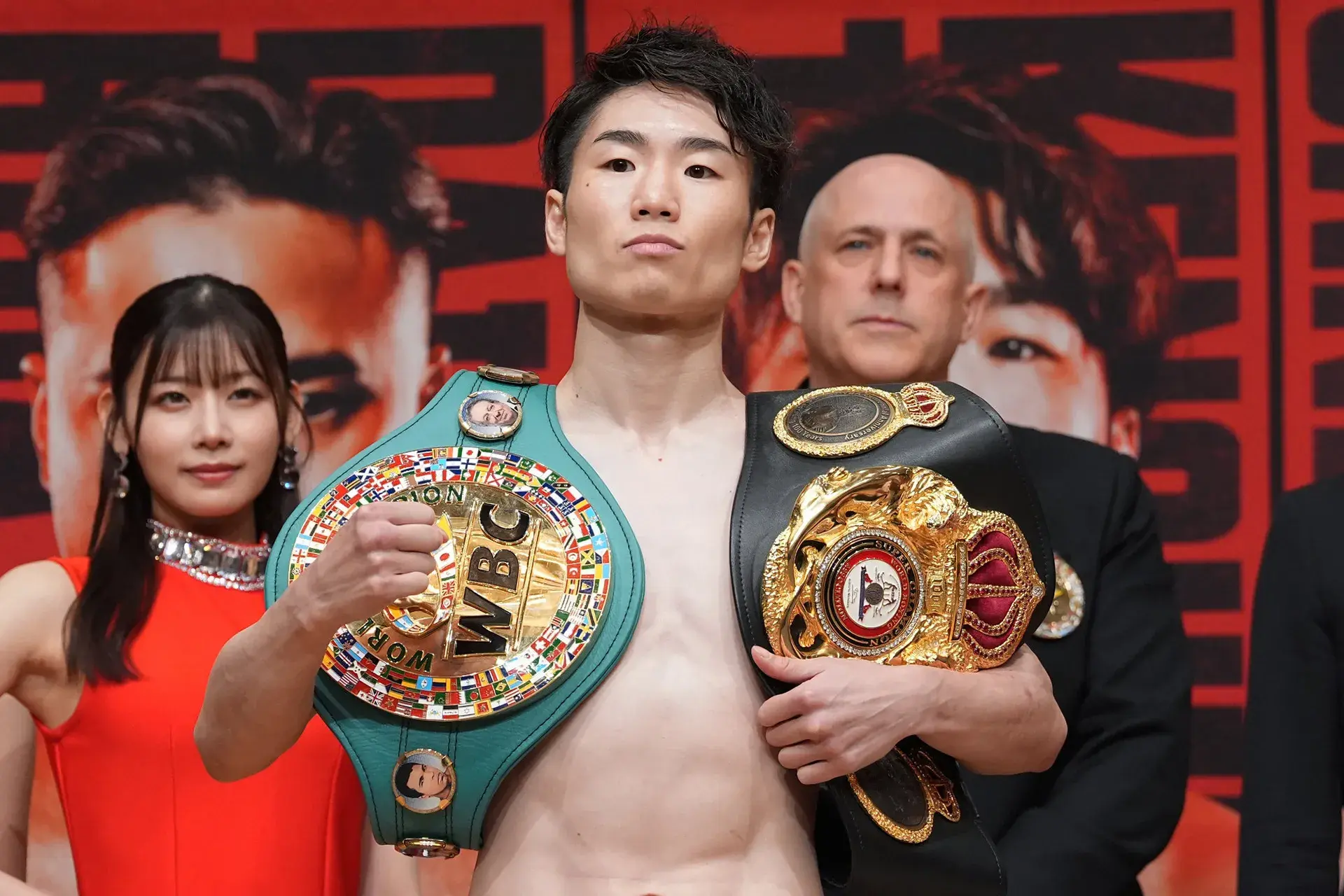 Kenshiro Teraji poses with WBA and WBC 112lbs titles after making weight for July 30 title defense against Ricardo Sandoval