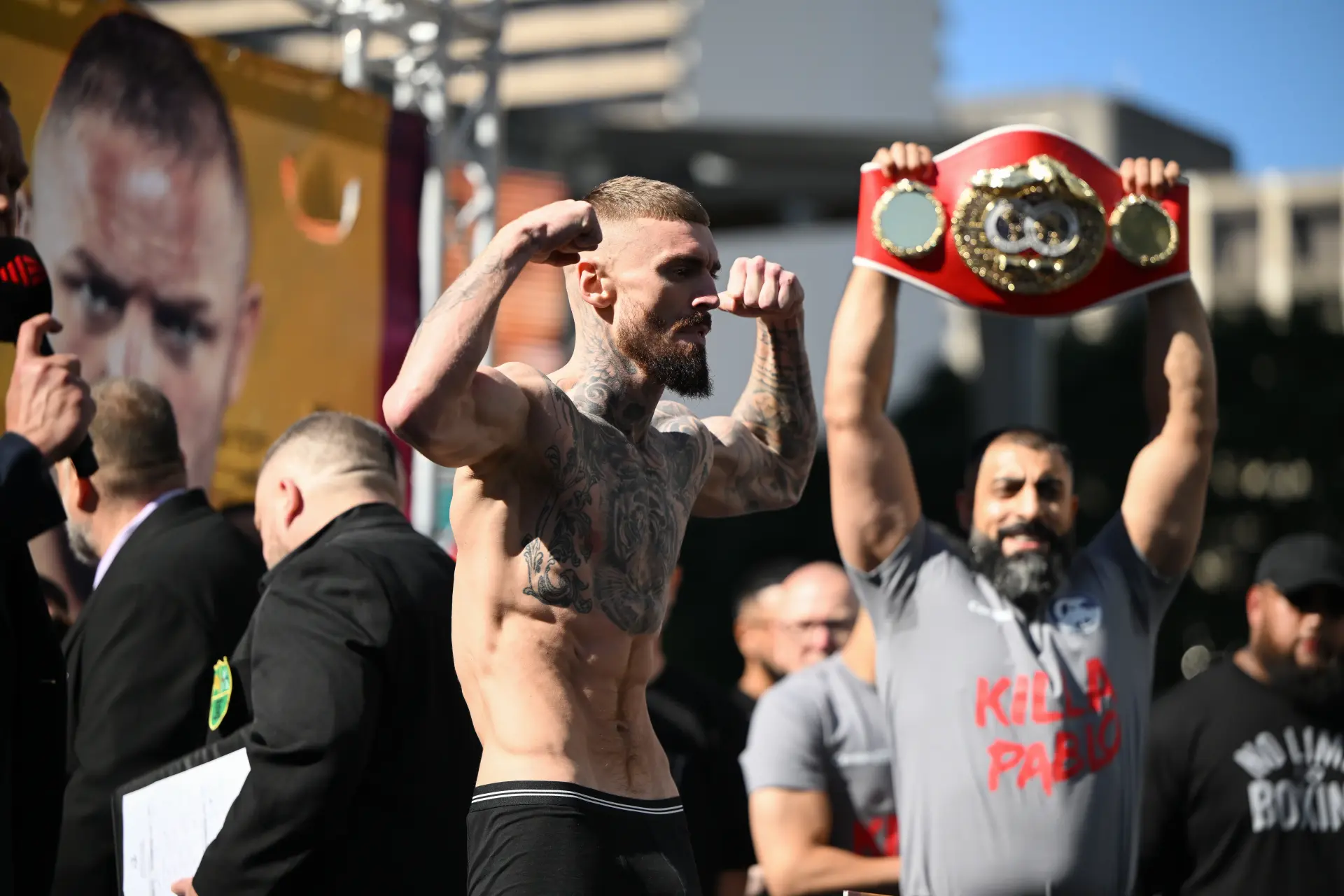 Lewis Crocker flexes his muscles at the weigh-in on the eve of his June 24 fight with Liam Paro