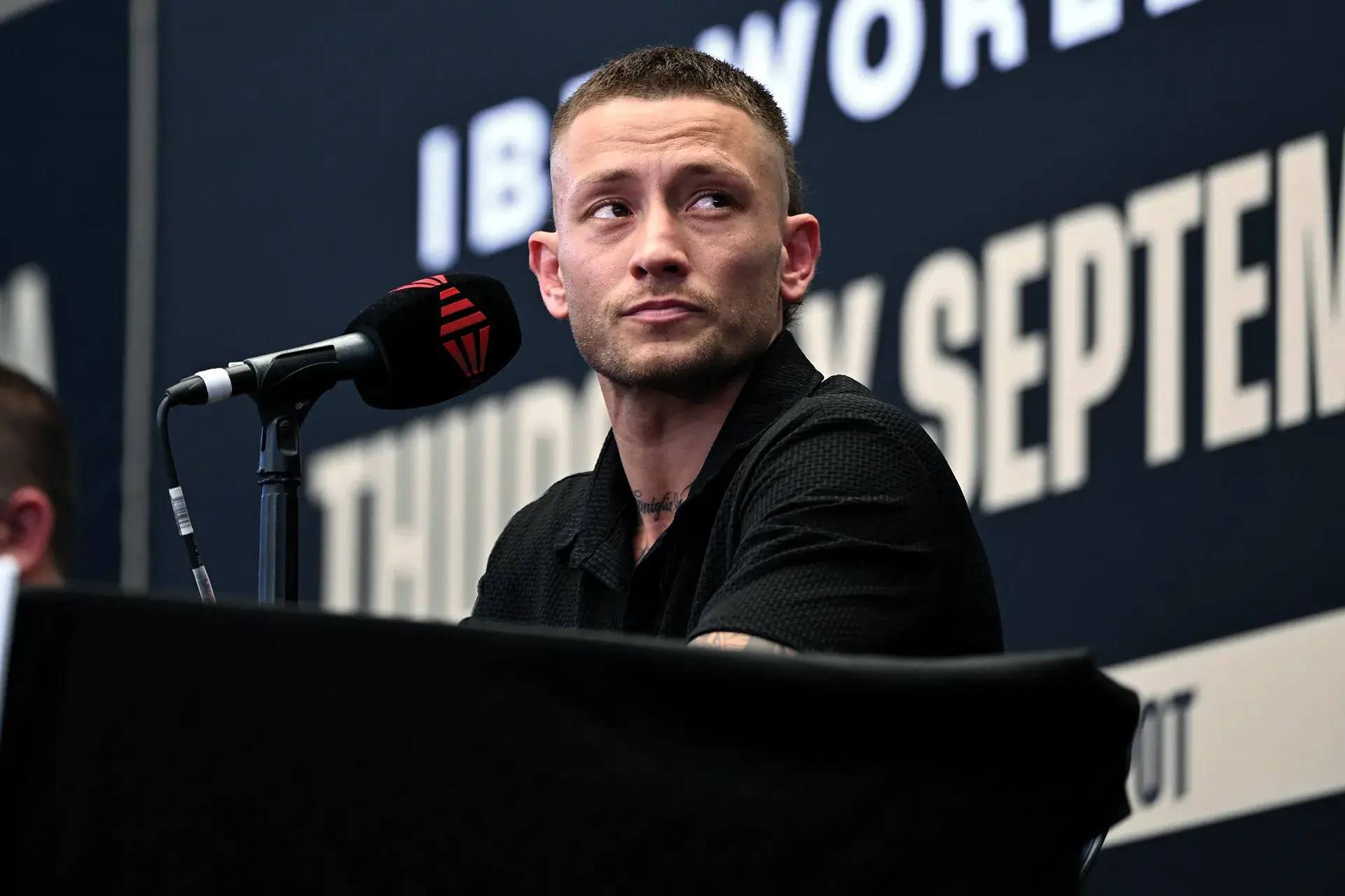 Liam Paro sits in front of a microphone at a press conference on September 16, 2025, ahead of his fight with David Papot.