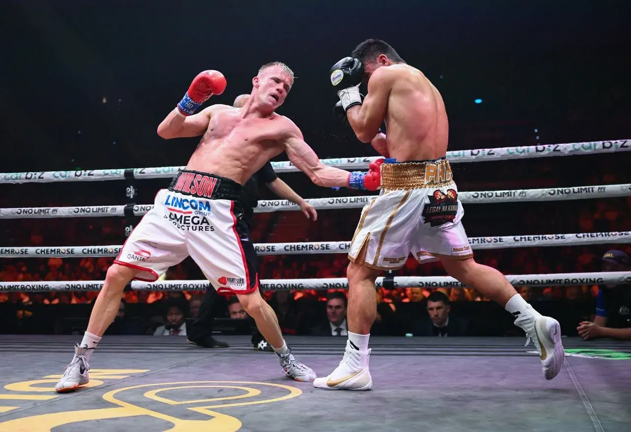 Liam Wilson lands a left hook to the body of Rodex Piala during their fight on January 16, 2026.