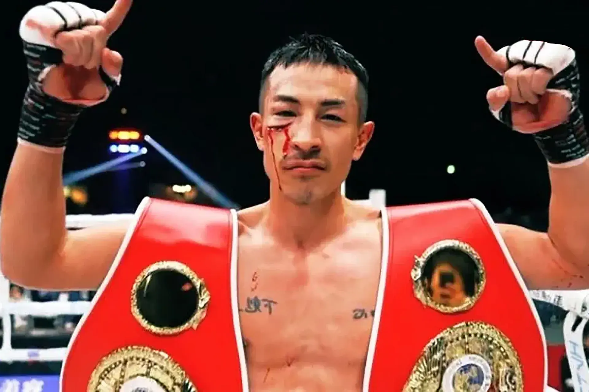 With blood pouring from a big cut on his right cheekbone, Masamichi Yabuki celebrates winning the IBF flyweight title from Angel Ayala on March 29, 2025.
