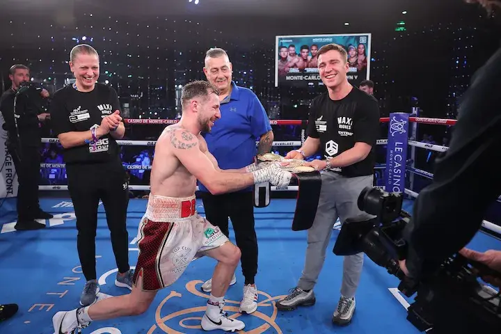 Maxi Hughes gives his belt to Reece Mould Photo Mark Robinson Matchroom Boxing
