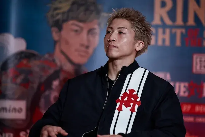 Naoya Inoue is seated onstage at a media event on December 22, 2025, ahead of his boxing match with Alan David Picasso.