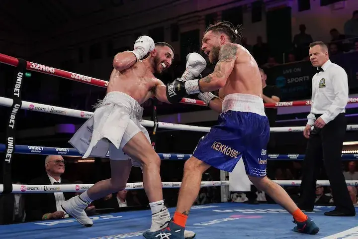 Francesco Grandelli attacks with Nathaniel Collins on the ropes