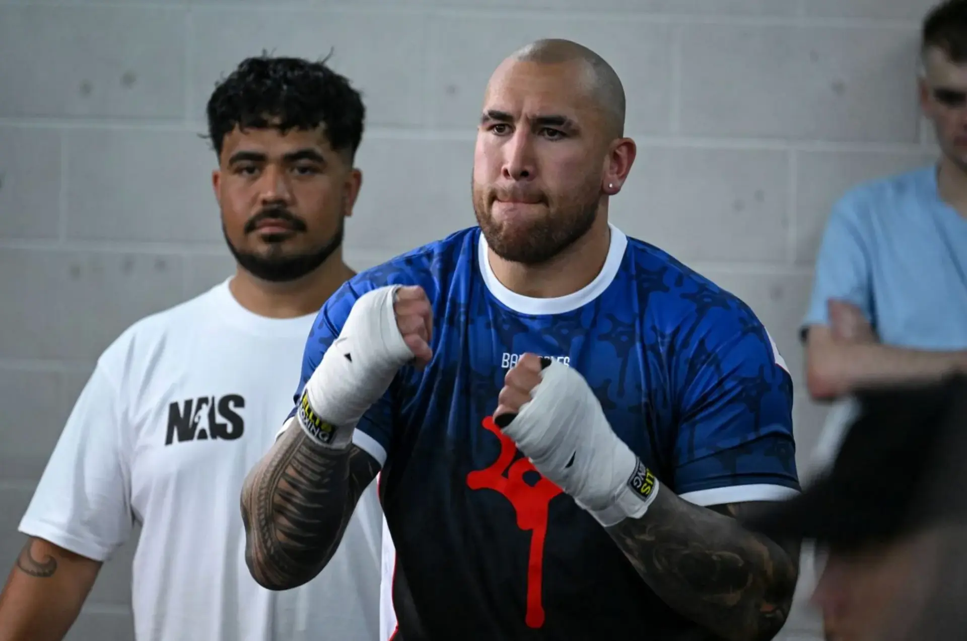Nelson Asofa-Solomona has his hands taped up backstage ahead of his first pro boxing match.