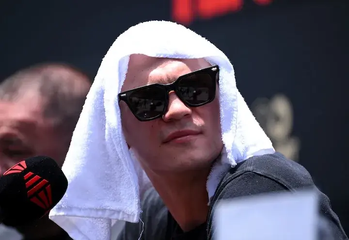 Nikita Tszyu is protecting his eyes and head from the sun during a press conference on January 13, 2026, ahead of his boxing match with Michael Zerafa.