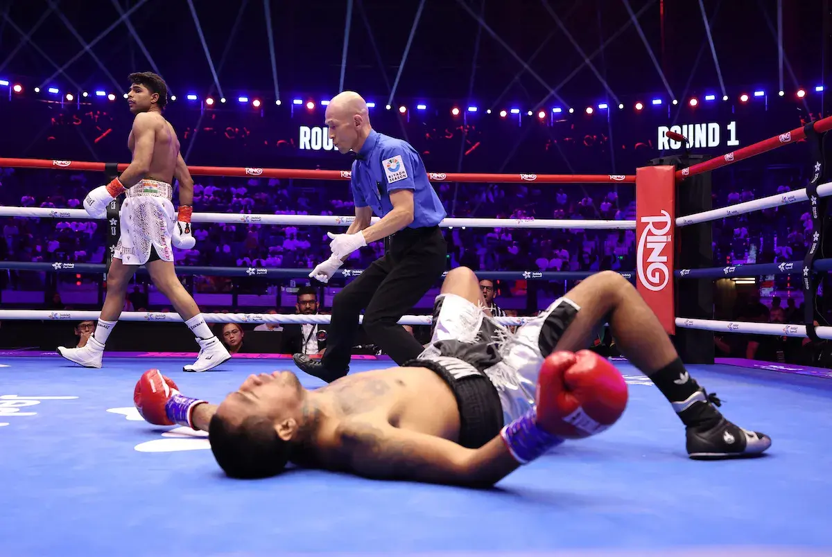 Nishant Dev stands over Cesar Diaz