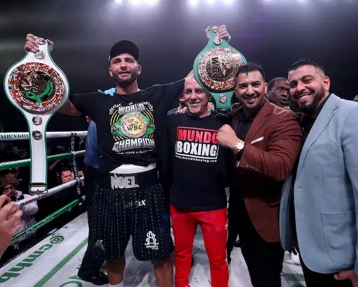 Noel Mikaelian holds a pair of cruiserweight title belts in the air after defeating Badou Jack in their rematch on December 13, 2025.