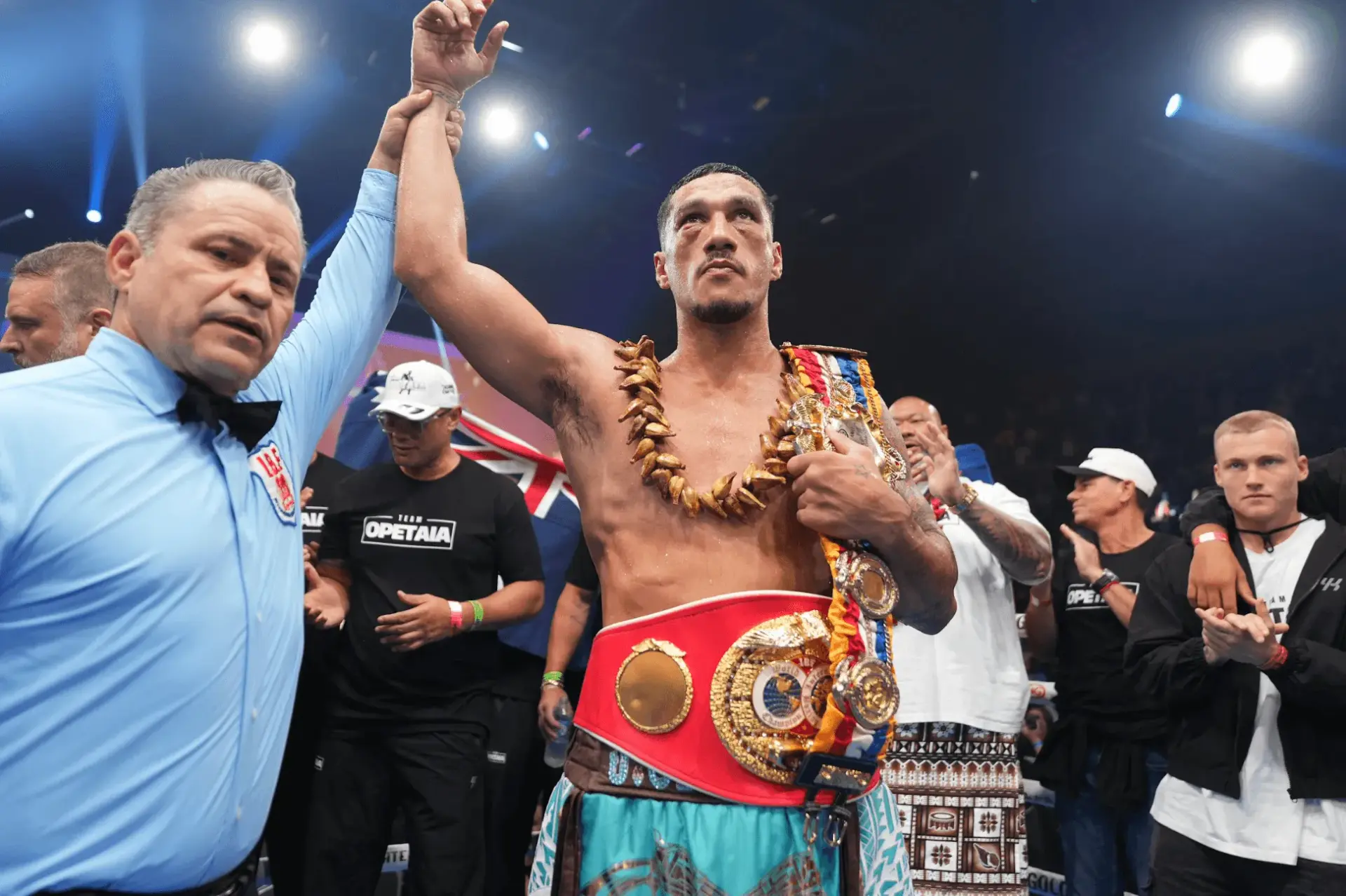 Jai Opetaia has his right hand raised in the air while wearing the IBF and Ring Magazine cruiserweight title belts following his victory over Huseyin Cinkara on December 6, 2025.
