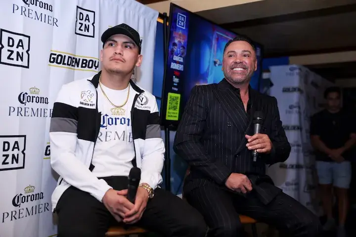 Boxing promoter Oscar De La Hoya of Golden Boy Promotions sits with junior middleweight fighter Vergil Ortiz Jnr.