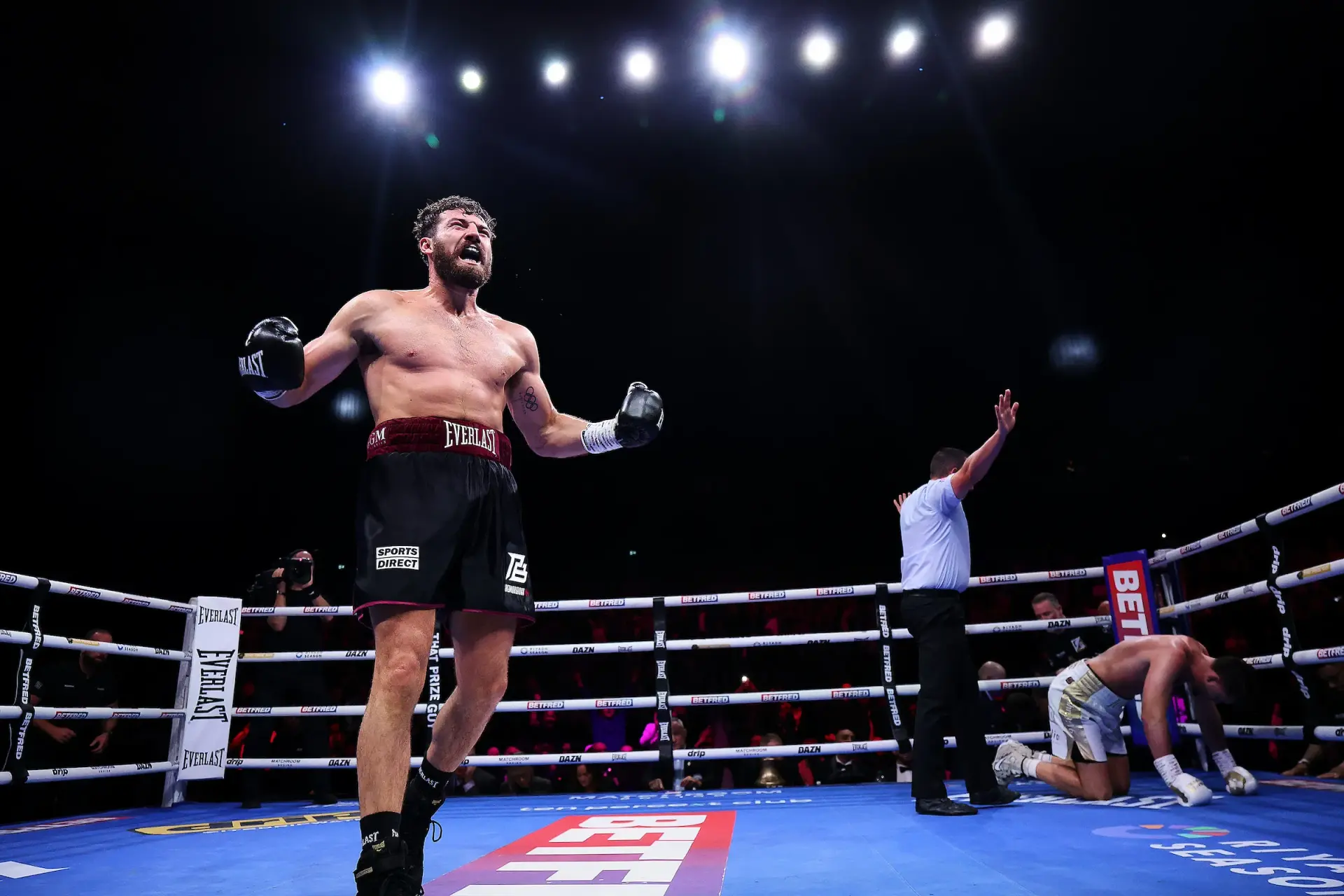 Pat Brown celebrates stopping John Hedges with a sickening body shot
