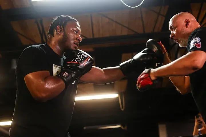 Pryce Taylor jabs a pad held by his trainer at a media workout on July 24, 2025.