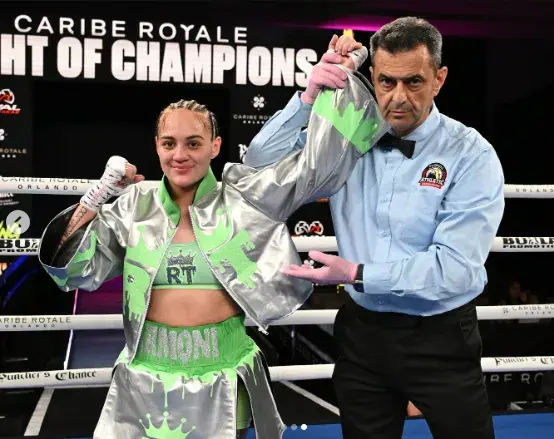 Reina Tellez holds her hands in the air after shutting out Mayela Perez in their boxing match on September 19, 2025.