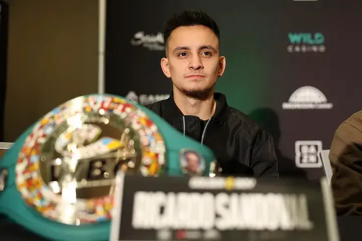 Ricardo Sandoval is pictured with a world title at a press conference.