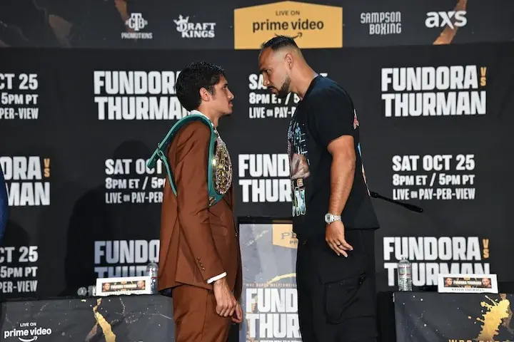 Keith Thurman stands on something to get a height advantage over Sebastian Fundora at a press conference ahead of their original date in October 2025.