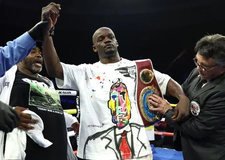 Troy Isley has his right arm raised in the air while a title belt is draped over his left shoulder following his victory over Etoundi Michel William on June 7, 2025