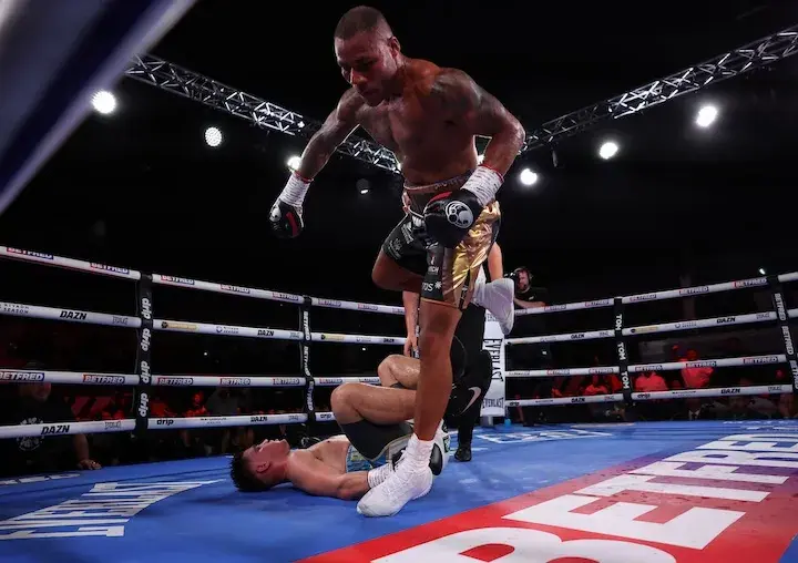 Troy Williamson steps over a fallen Mark Dickinson during their boxing match on September 6, 2025.