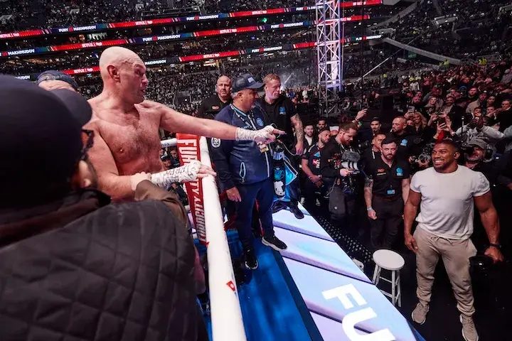 Tyson Fury points at Anthony Joshua in the crowd after defeating Arslanbek Makhmudov in Tottenham, England. (April 11, 2026)