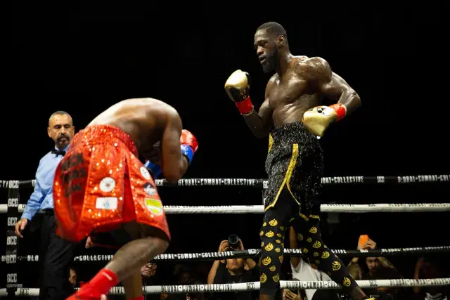 Deontay Wilder stands ready to throw at a crouching Tyrell Herndon during their fight on June 27, 2025.