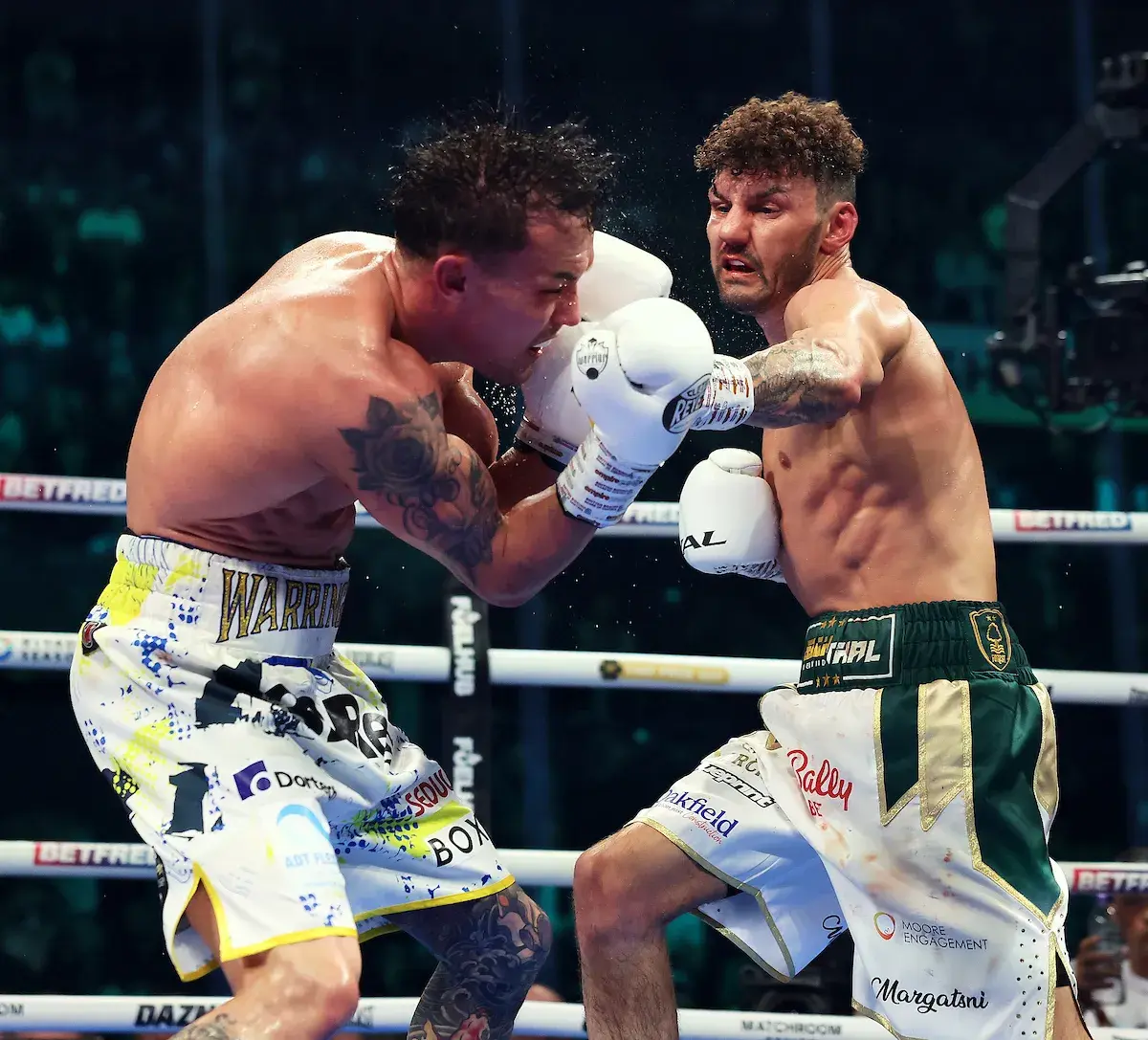 Leigh Wood lands a shot on Josh Warrington