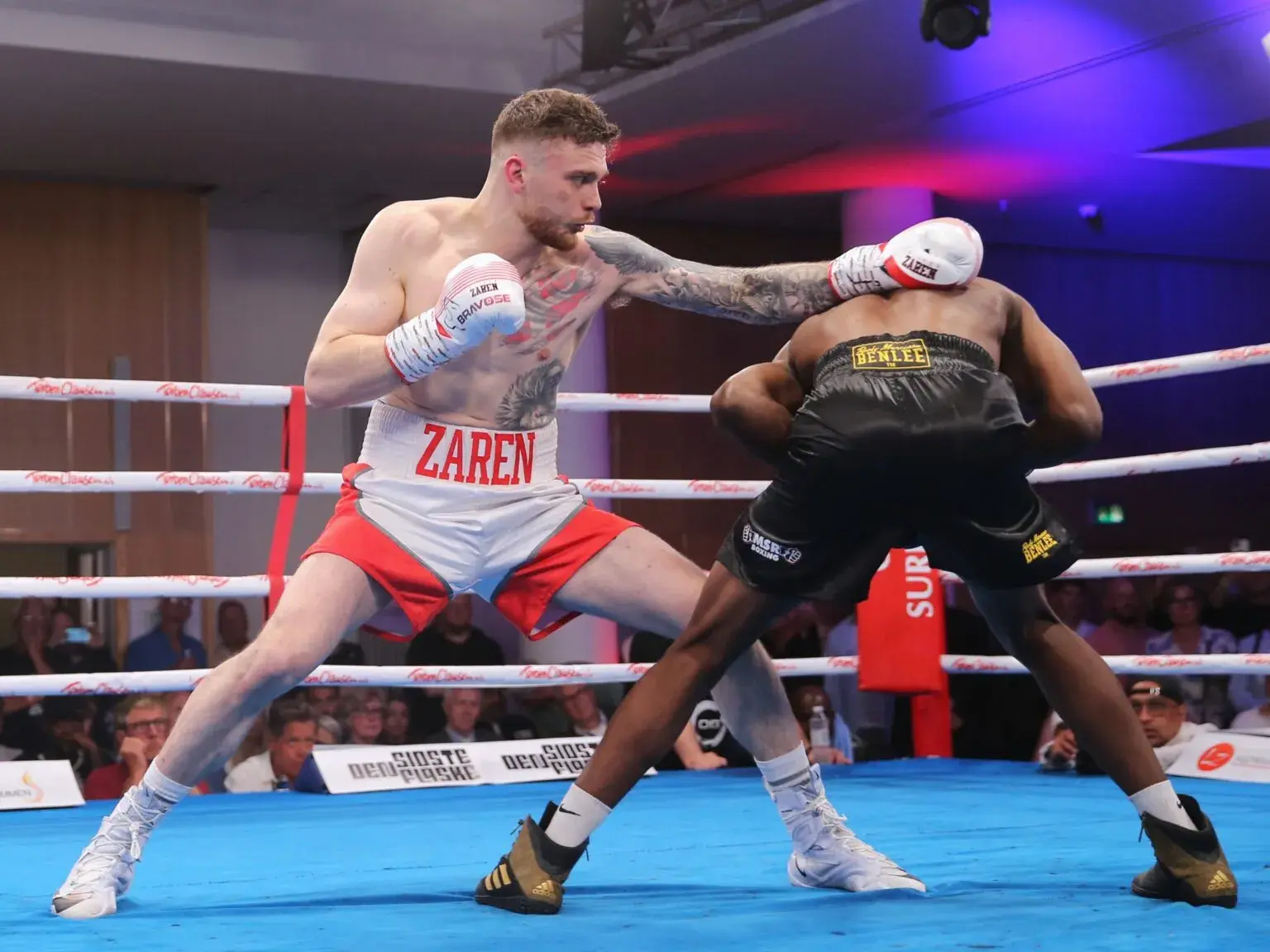 Oliver Zaren throws a punch at a ducking opponent