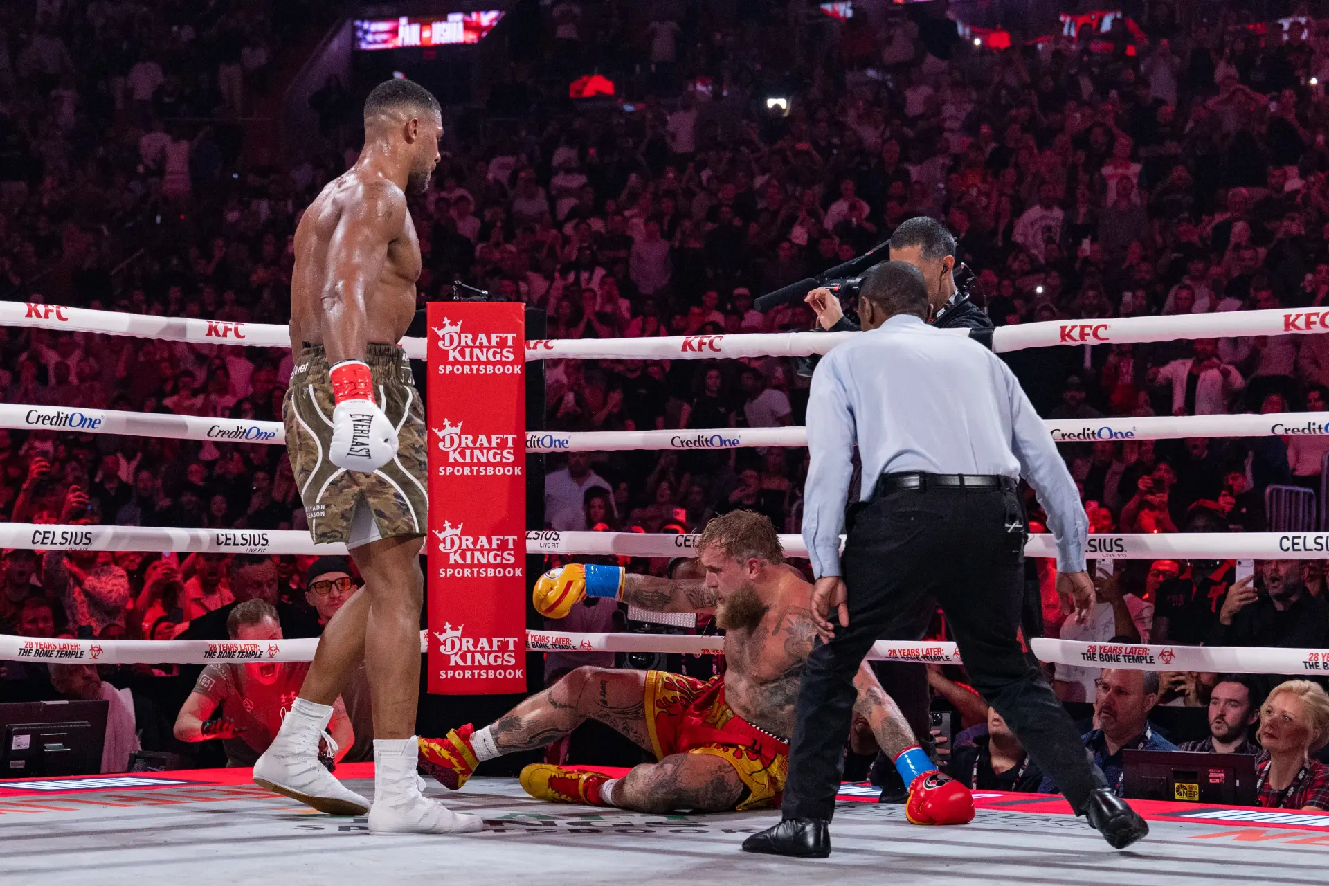 Anthony Joshua stands over a fallen Jake Paul in their boxing match on December 19, 2025.