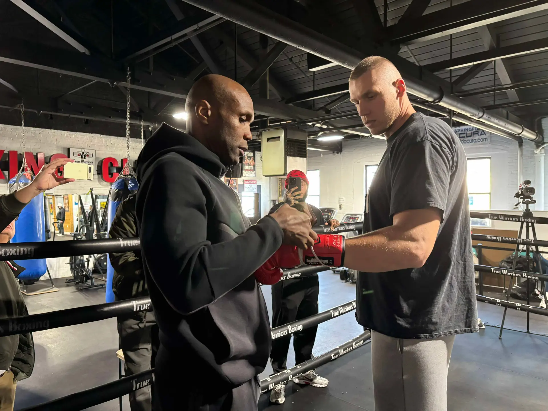 Damian Knyba gets his gloves laced by trainer Shaun George.
