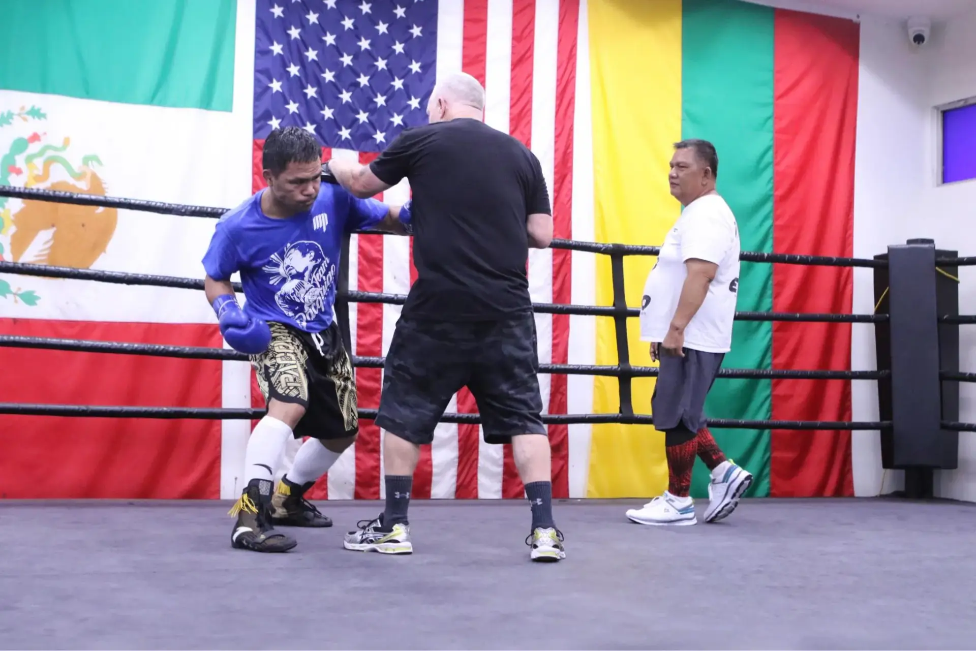Manny Pacquiao lands a left hand on the pads with Freddie Roach