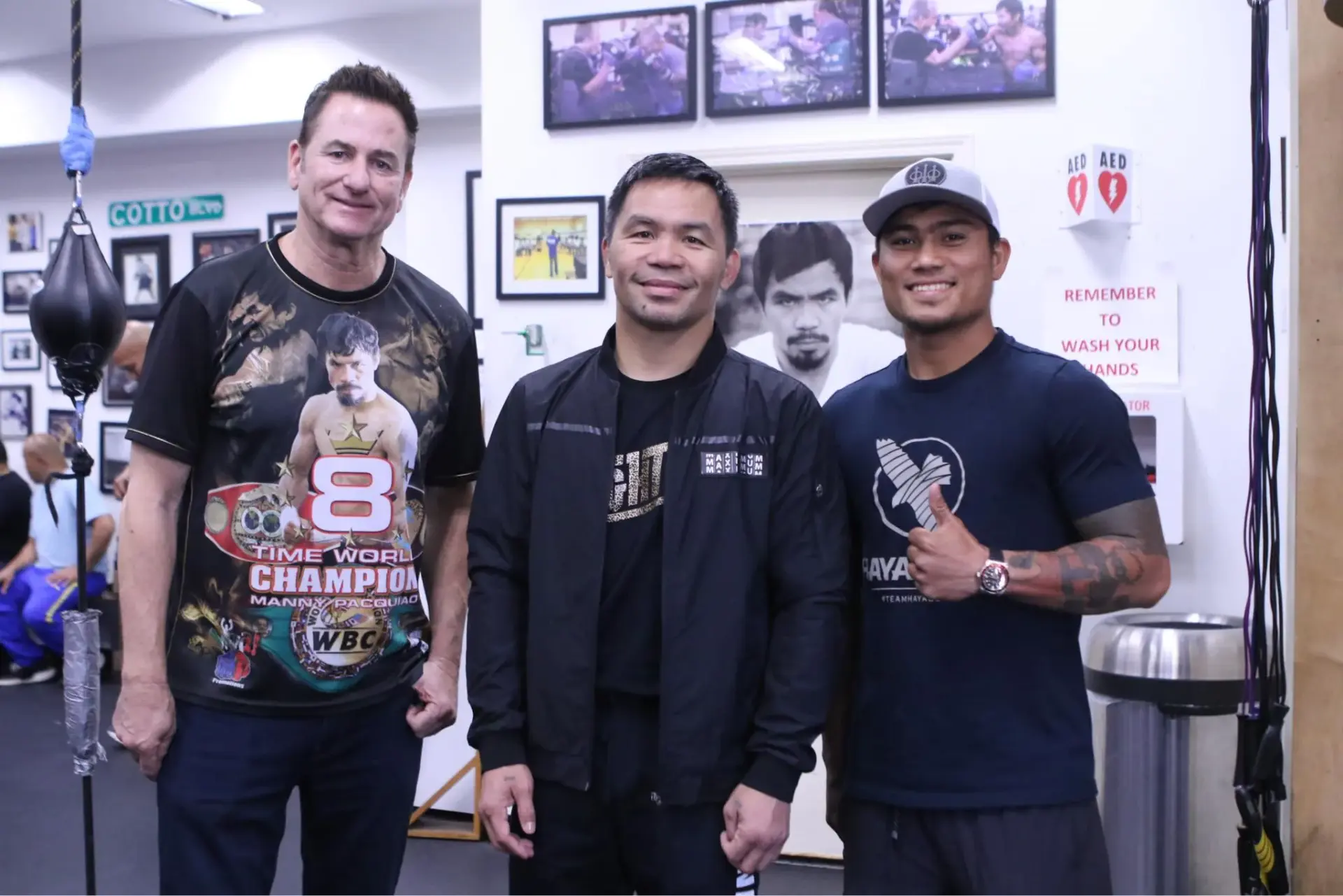 Manny Pacquiao (center) with Mark Magsayo and Sean Gibbons.