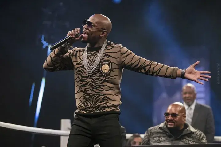 Floyd Mayweather is pictured with Leonard Ellerbe and Sam Watson in the background ahead of Mayweather's 2017 fight with Conor McGregor.