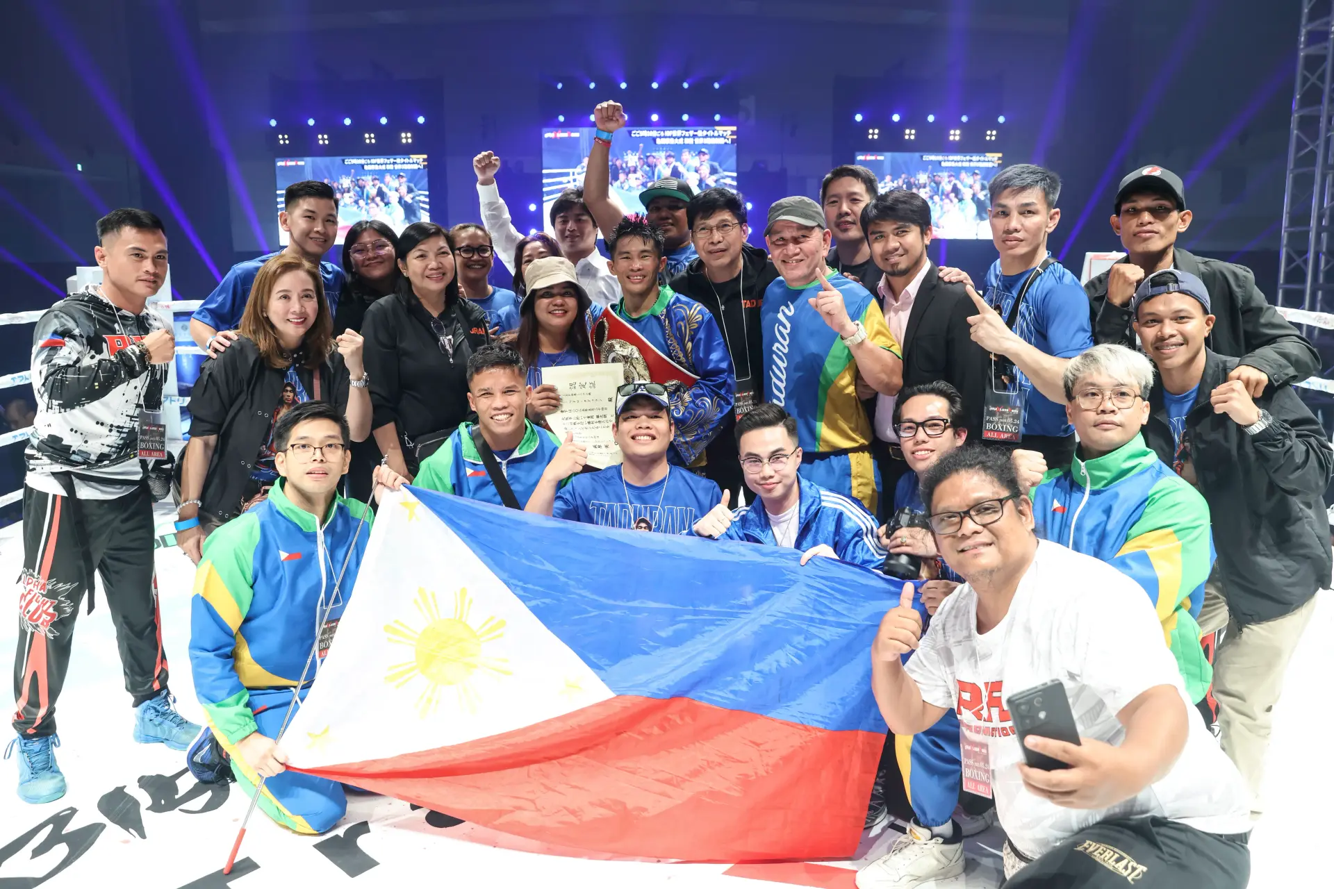Pedro Taduran and his team pose with the Philippines flag after defeating Ginjiro Shigeoka a second time