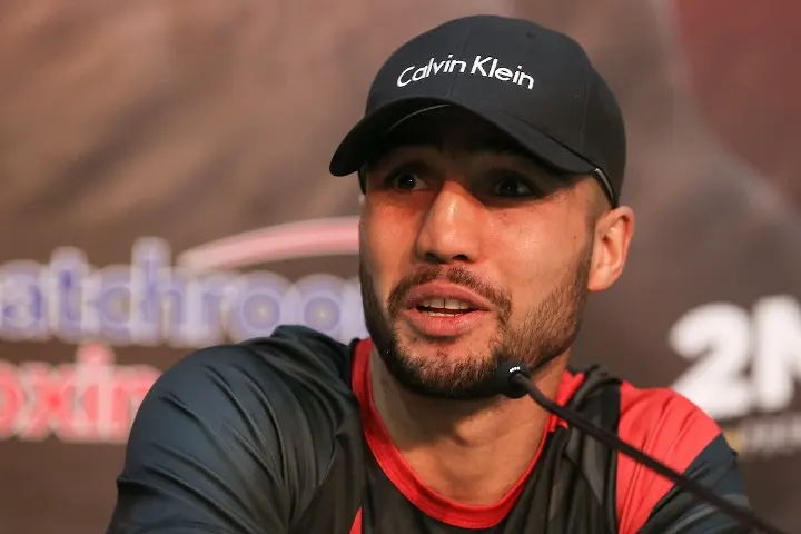 Welterweight contender Shakhram Giyasov sits in front of a microphone at a press conference.